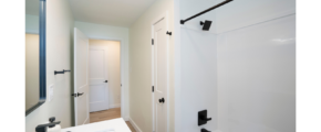 a bathroom with a sink, mirror and bathtub