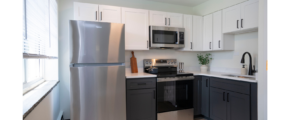 a kitchen with a silver refrigerator freezer next to a window