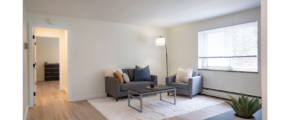 a living room filled with furniture and a window