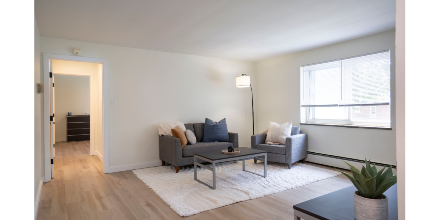 a living room filled with furniture and a window