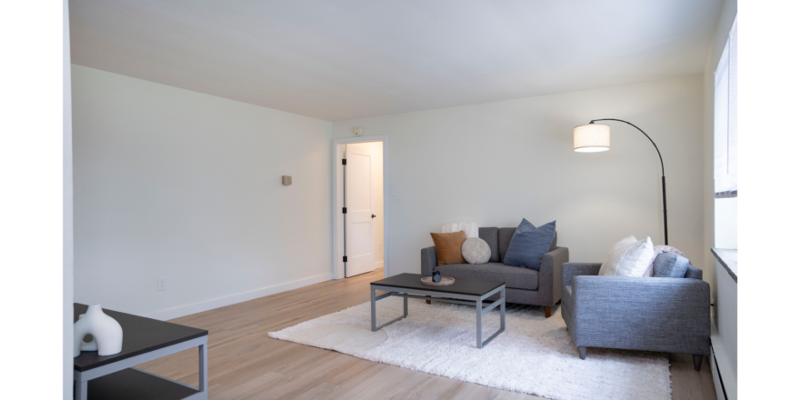 a living room filled with furniture and a lamp