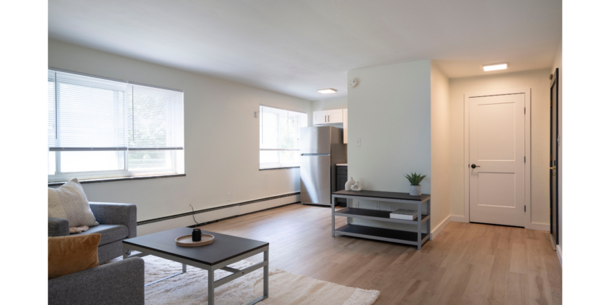 a living room filled with furniture and a window