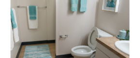 a white toilet sitting next to a bathroom sink