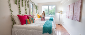 a woman sitting on a bed in a bedroom