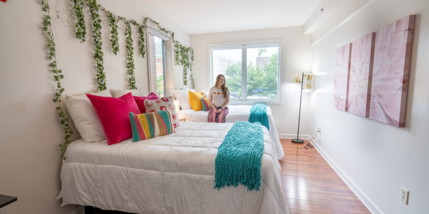 a woman sitting on a bed in a bedroom