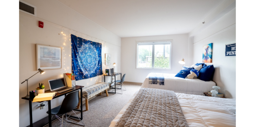 a bed room with a neatly made bed and a desk