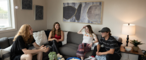 a group of people sitting on a couch in a living room