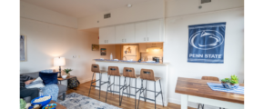 a living room filled with furniture and a bar