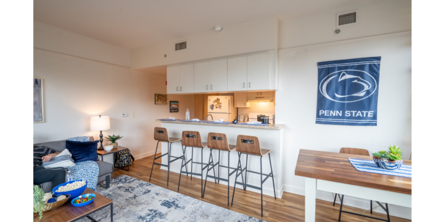 a living room filled with furniture and a bar