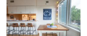 a kitchen with a table and chairs next to a window