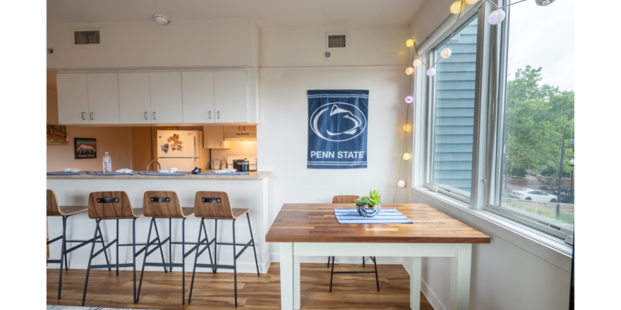 a kitchen with a table and chairs next to a window