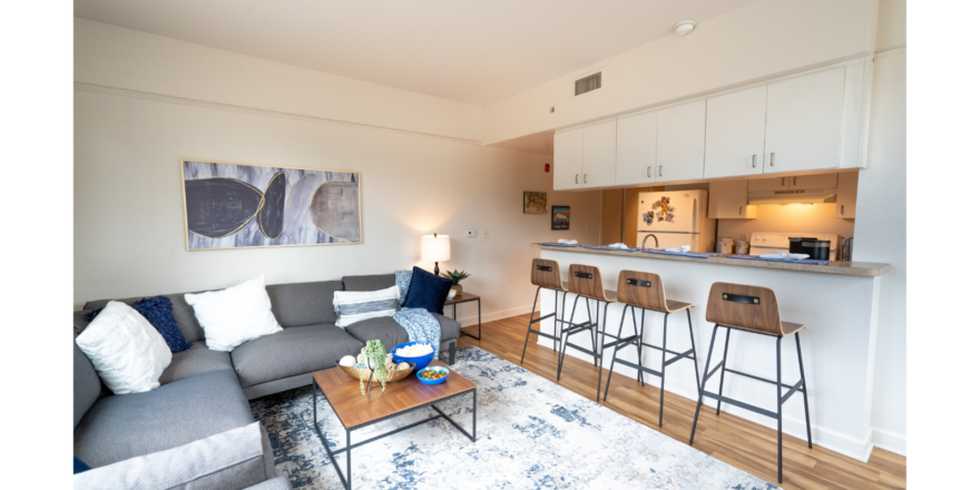 a living room filled with furniture and a bar