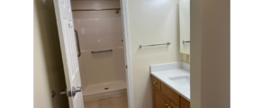 a bathroom with a sink, mirror, and shower