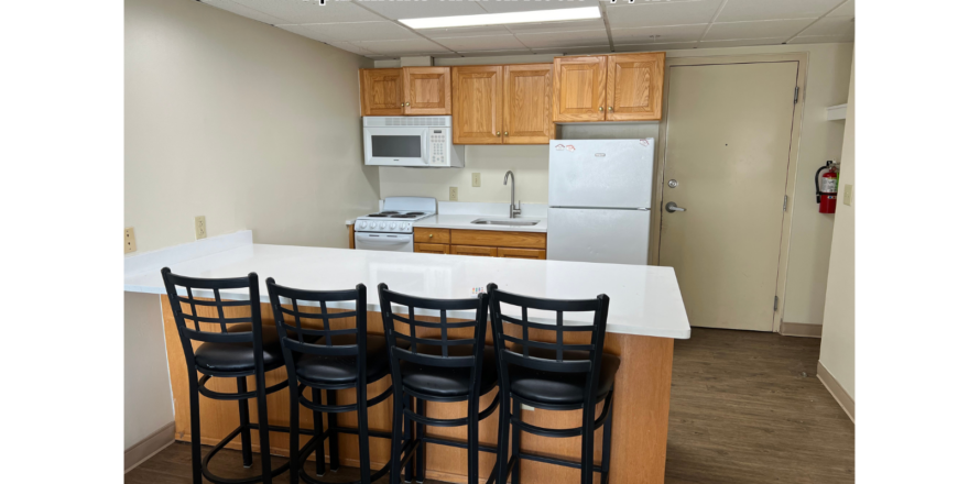 a kitchen with a center island and a breakfast bar