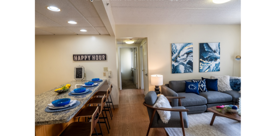 a living room filled with furniture and a kitchen