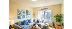 a living room filled with furniture and a large window