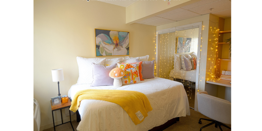 a bedroom with a white bed and a yellow blanket