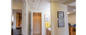 a hallway leading to a bedroom and a kitchen