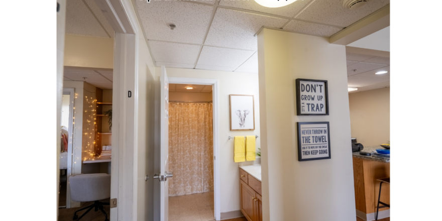 a hallway leading to a bedroom and a kitchen