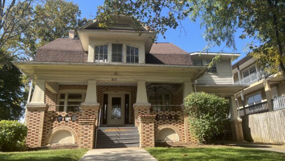 a brick house with a large front porch