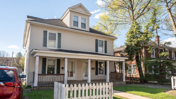 a house with a white picket fence in front of it