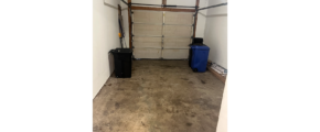 an empty garage with two suitcases in it