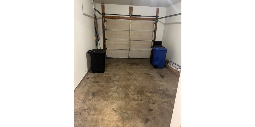 an empty garage with two suitcases in it