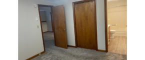 an empty room with two wooden doors in it