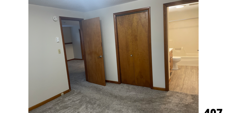 an empty room with two wooden doors in it