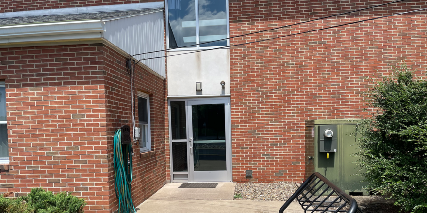 brick building with glass door and windows