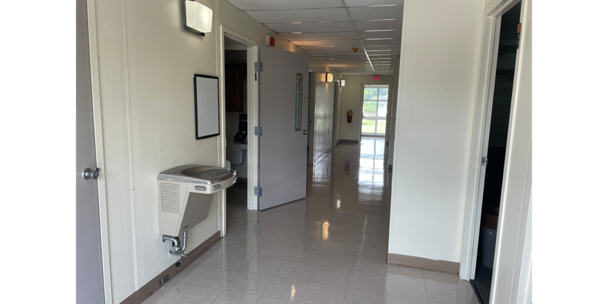 a long hallway with a heater on the wall