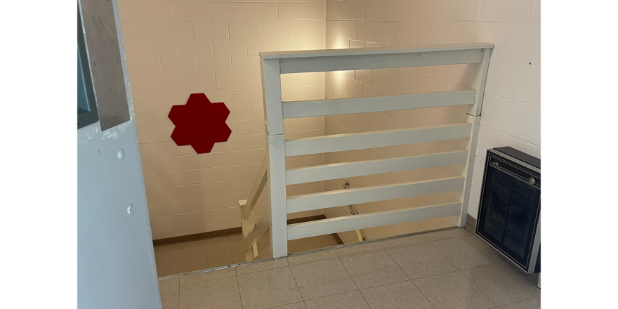 white railing, white walls, white tile, leading down to stairs