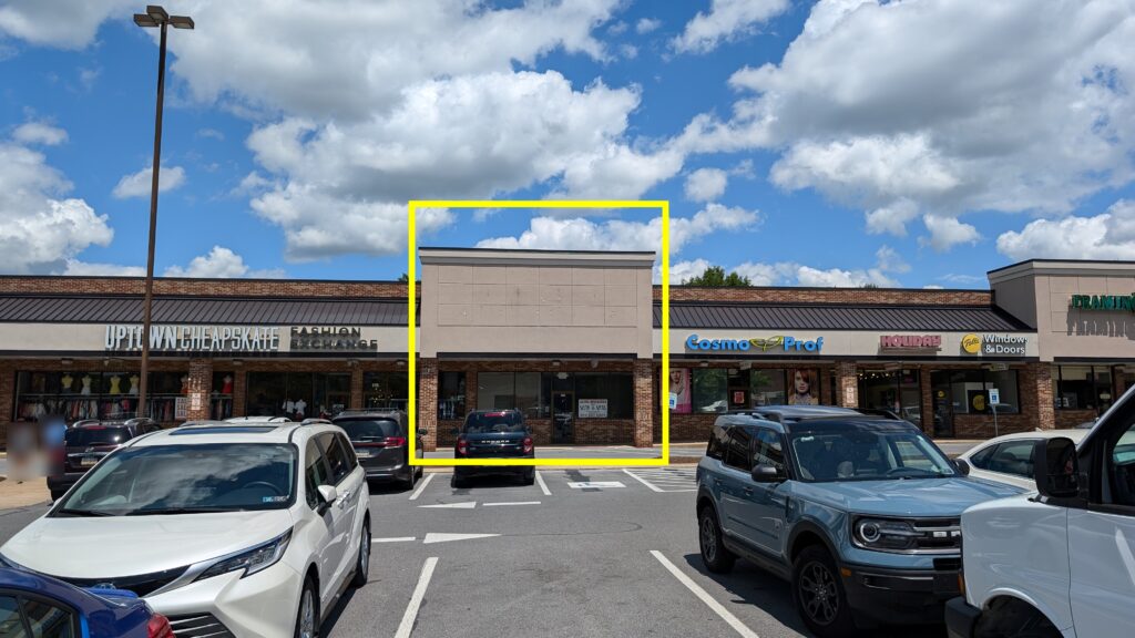 a parking lot with cars parked in front of a store