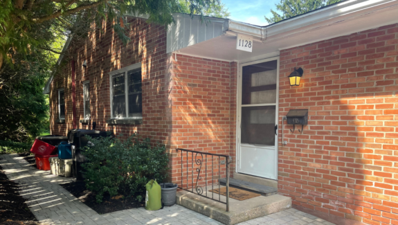 a brick house with a white front door