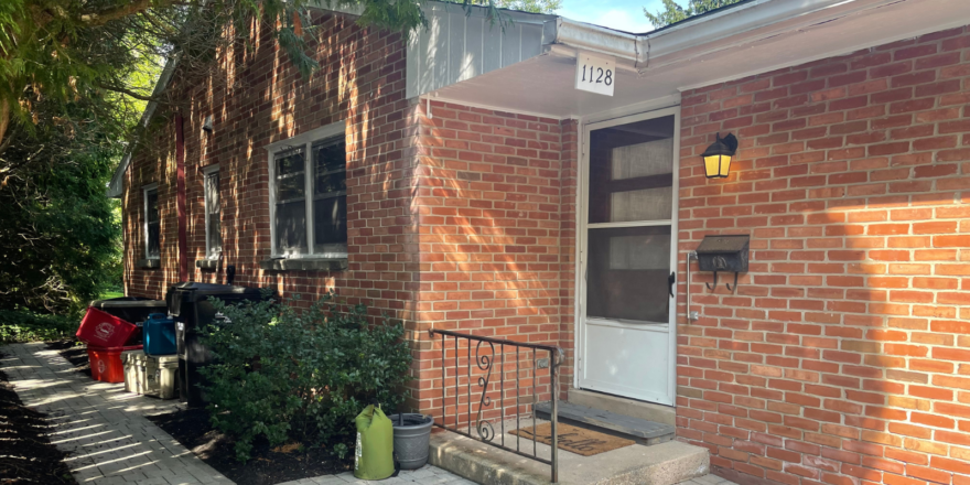 a brick house with a white front door