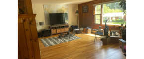 a living room filled with furniture and a flat screen tv