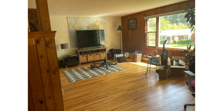 a living room filled with furniture and a flat screen tv