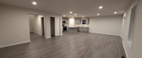 an empty living room with hard wood floors