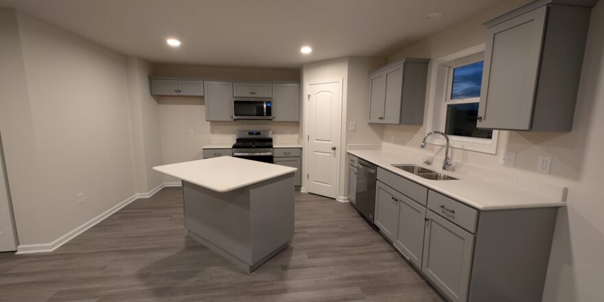 a kitchen with a center island in a room