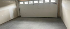 an empty garage with a garage door open