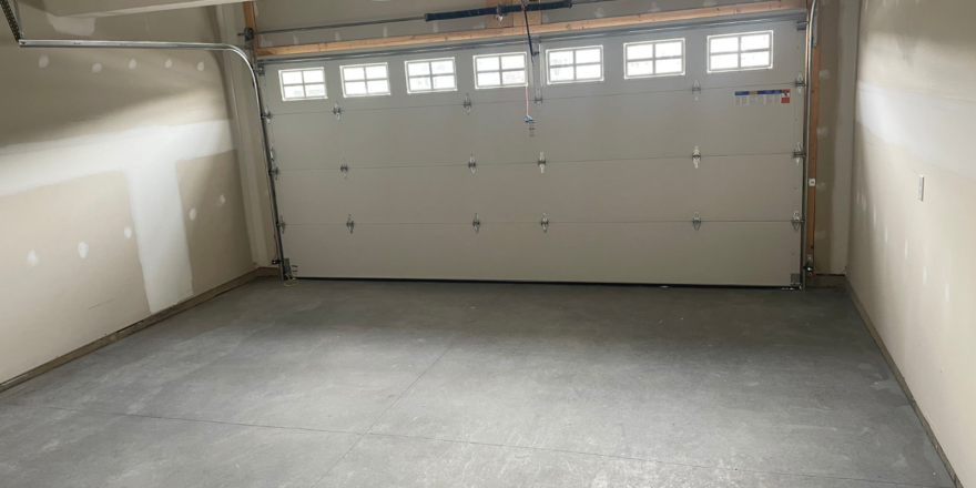 an empty garage with a garage door open