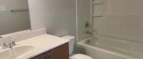 a bathroom with a toilet, sink, and bathtub