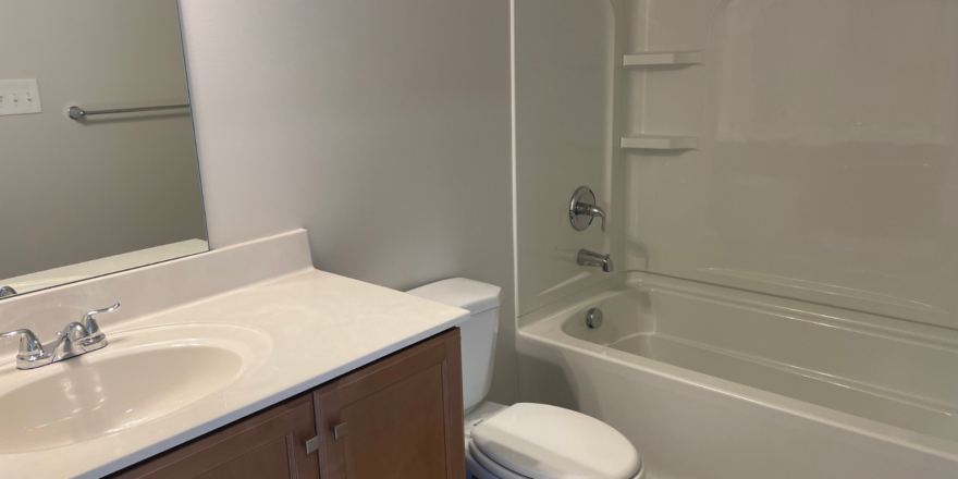 a bathroom with a toilet, sink, and bathtub