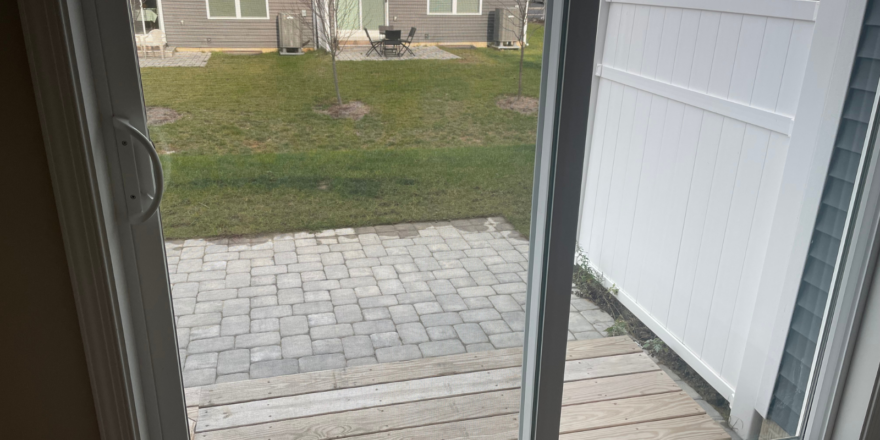 a sliding glass door leading to a back yard