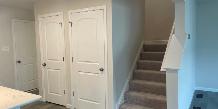 a kitchen with a counter top and stairs