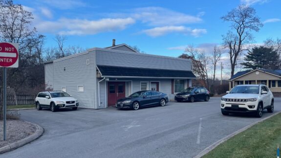 three cars parked in front of a building